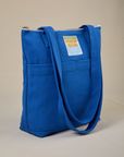 Angled view of Over-Shoulder Zip Mini Tote in Royal Blue