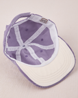 Dugout Corduroy Hat in Fade Grape flipped over. White satin under-bill