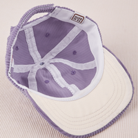 Dugout Corduroy Hat in Fade Grape flipped over. White satin under-bill