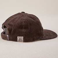 Side view of Dugout Corduroy Hat in Espresso Brown. Big Bud label sewn on edge of hat.