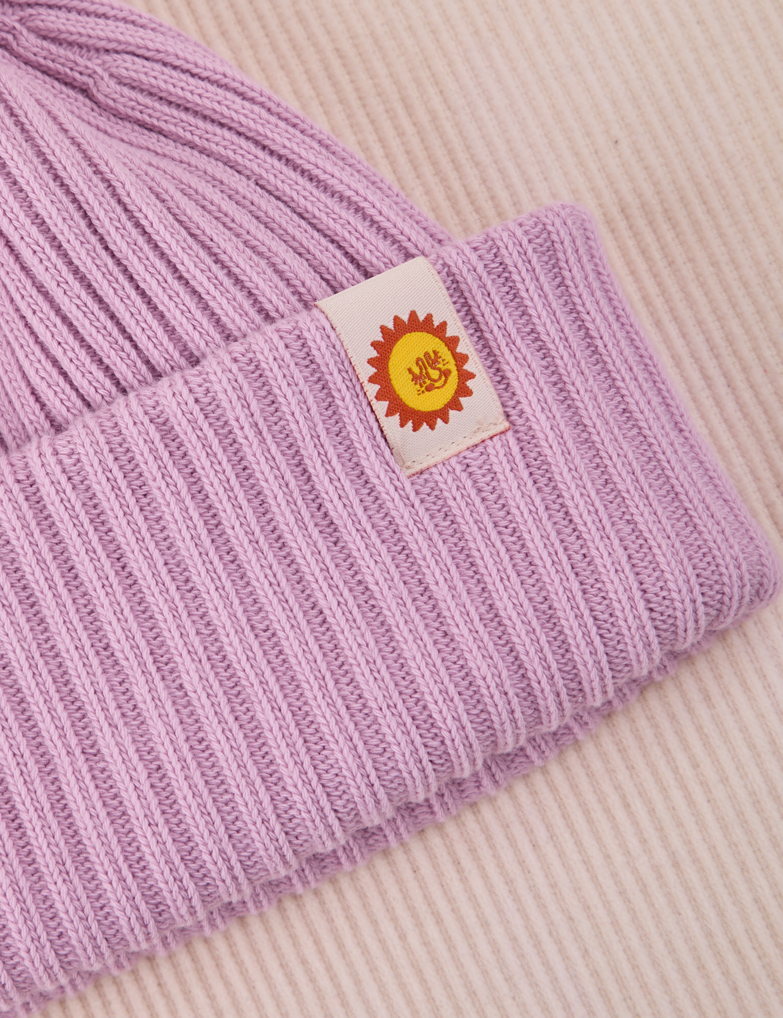 Ribbed Beanie in Lilac close up of sun baby tag