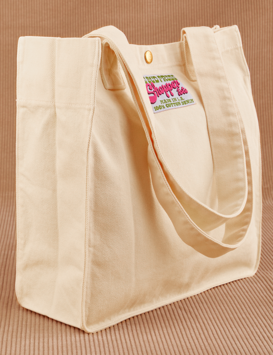 Angled view of Shopper Tote Bag in Vintage Off-White