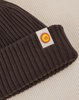 Ribbed Beanie in Espresso Brown close up of sun baby tag