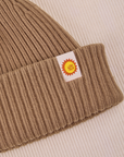 Ribbed Beanie in Desert Brown close up of sun baby tag