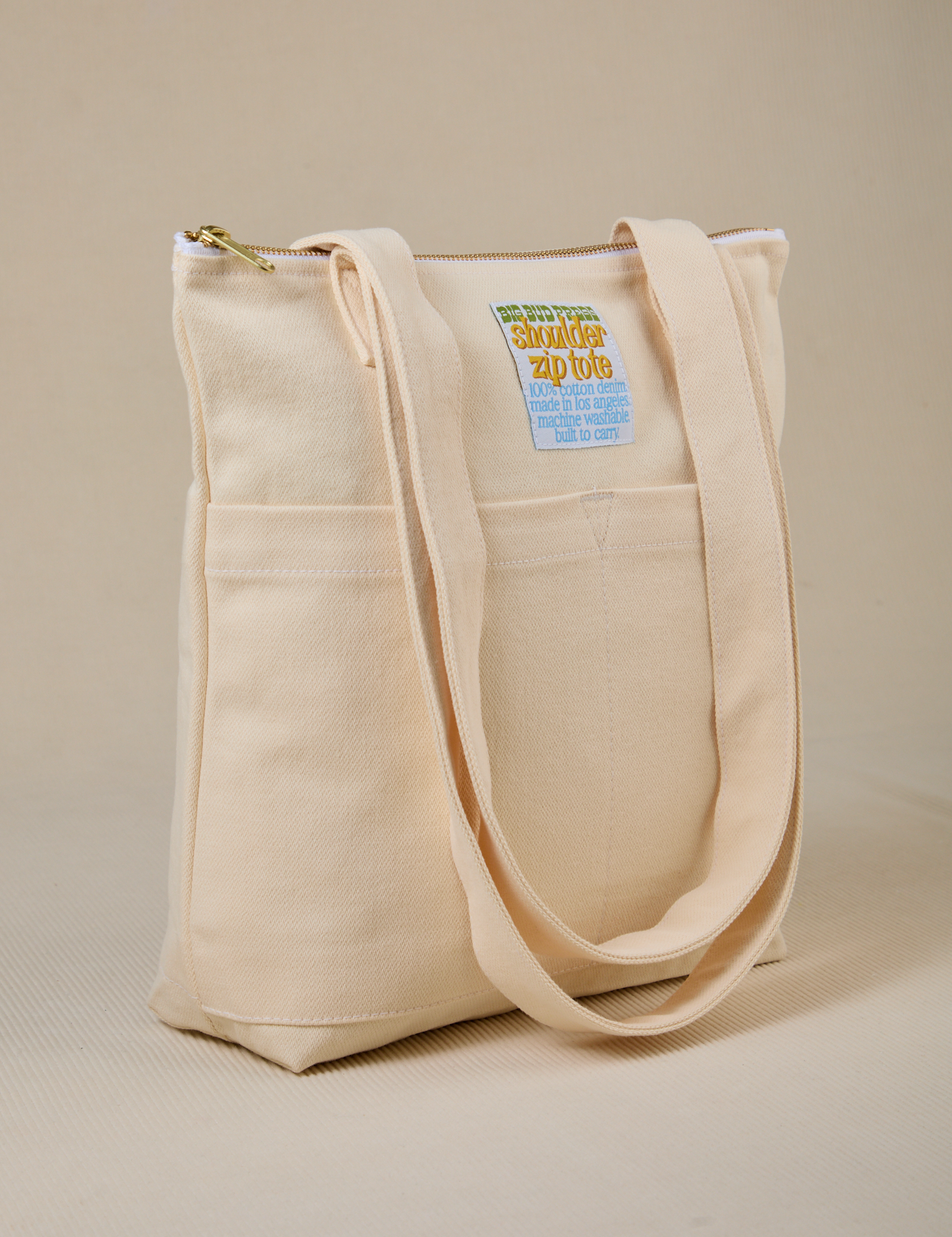 Angled view of Over-Shoulder Zip Mini Tote in Vintage Tee Off-White