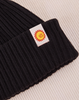 Ribbed Beanie in Basic Black close up of sun baby tag