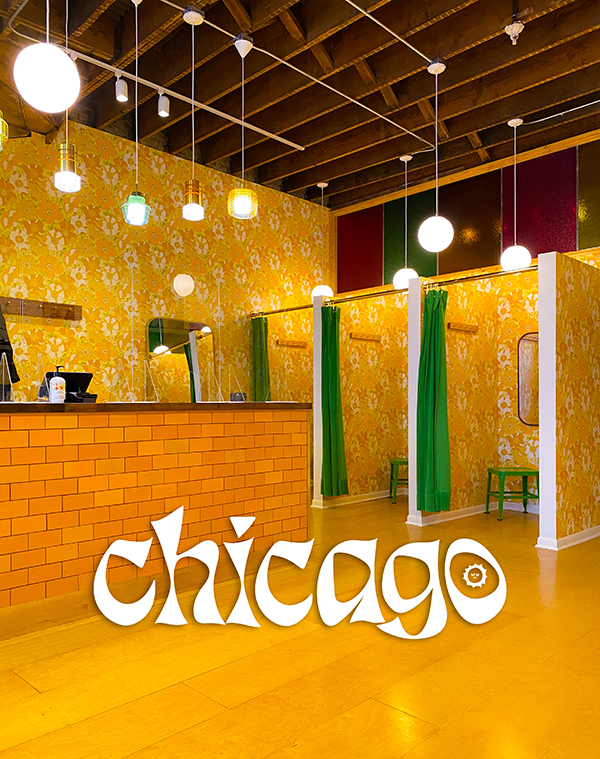 Interior of Big Bud Press Chicago store. Yellow floral wallpaper on walls.