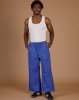 Isaac is 5'10" wearing M Cornflower Blue Action Pant with Vintage Tee Off-White Tank Top