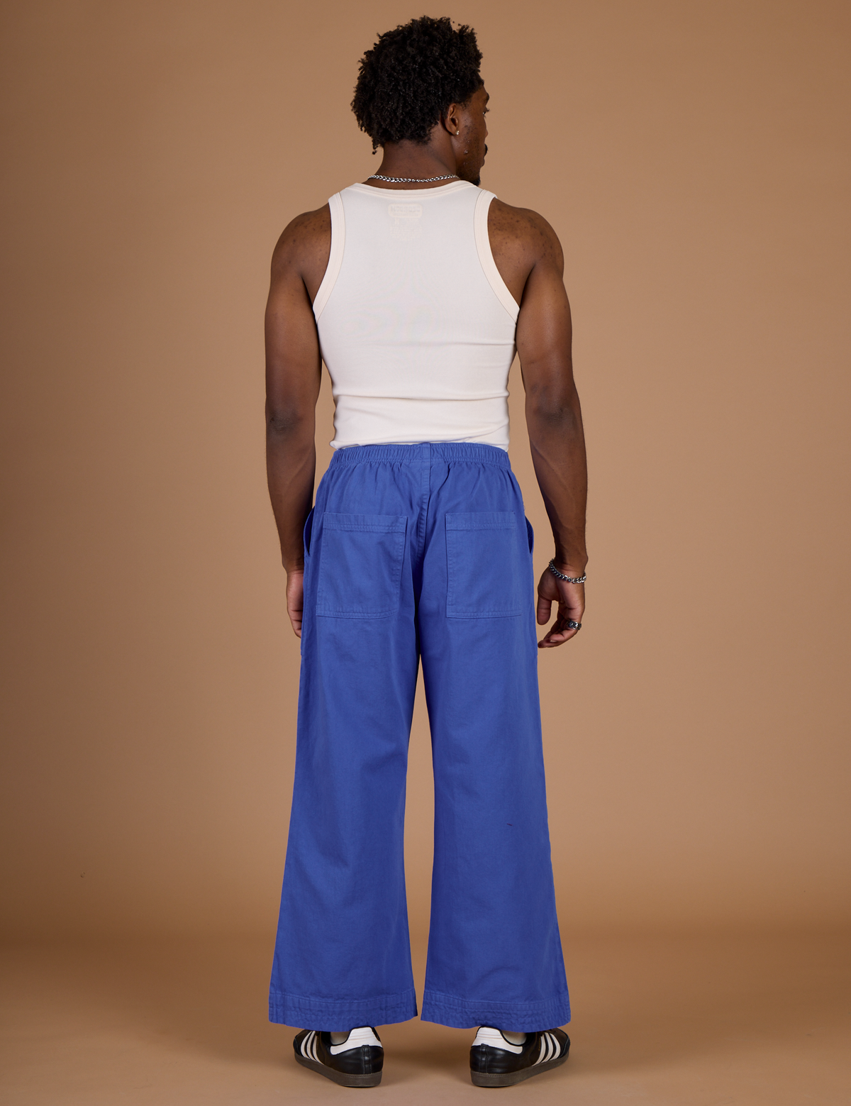 Back view of Isaac wearing the Cornflower Blue Action Pant