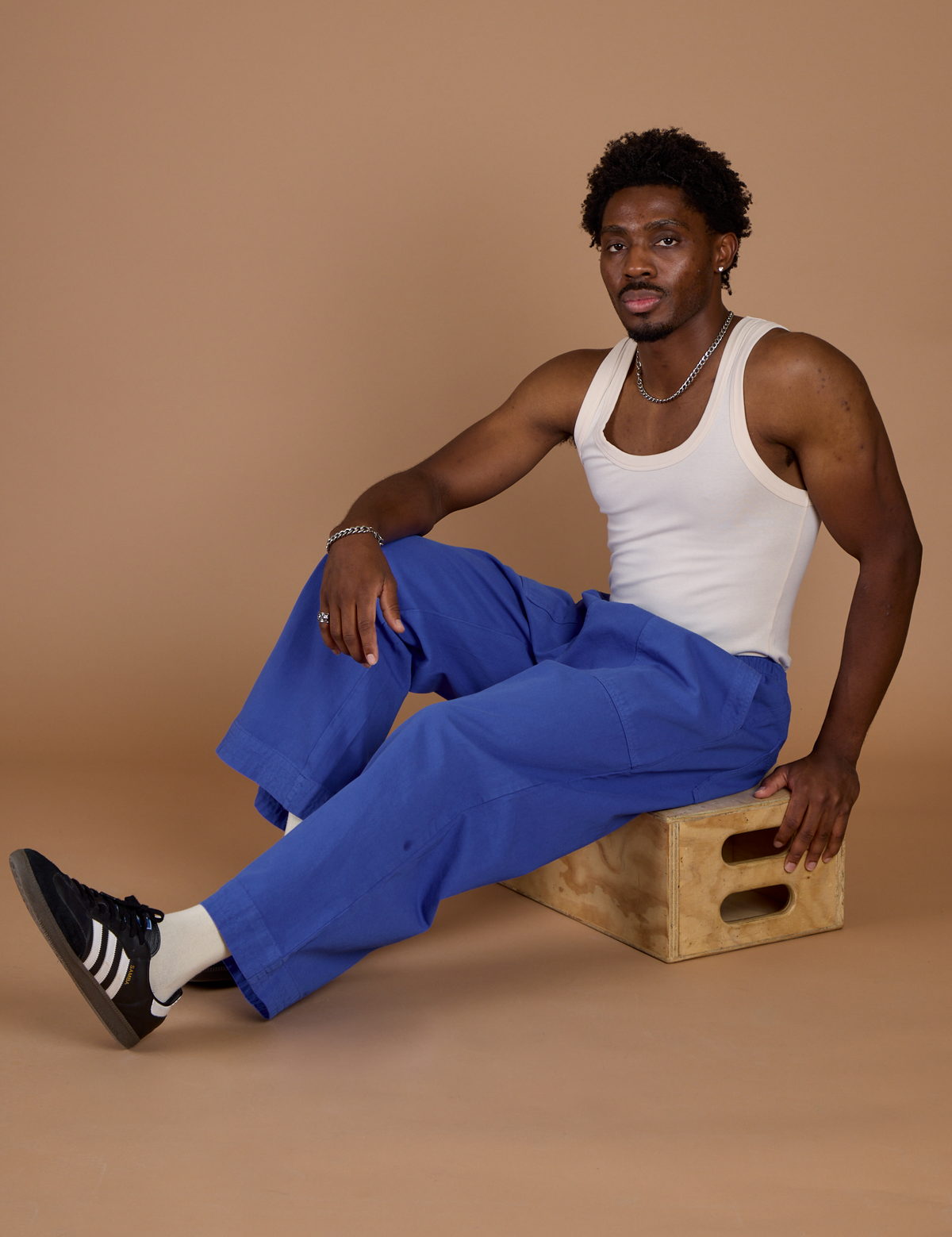 Isaac wearing the Cornflower Blue Action Pant with the Vintage Tee Off-White Tank Top