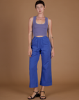 Alex 5'8" and wearing XXS Cornflower Blue Action Pant with the Faded Grape Cropped Tank