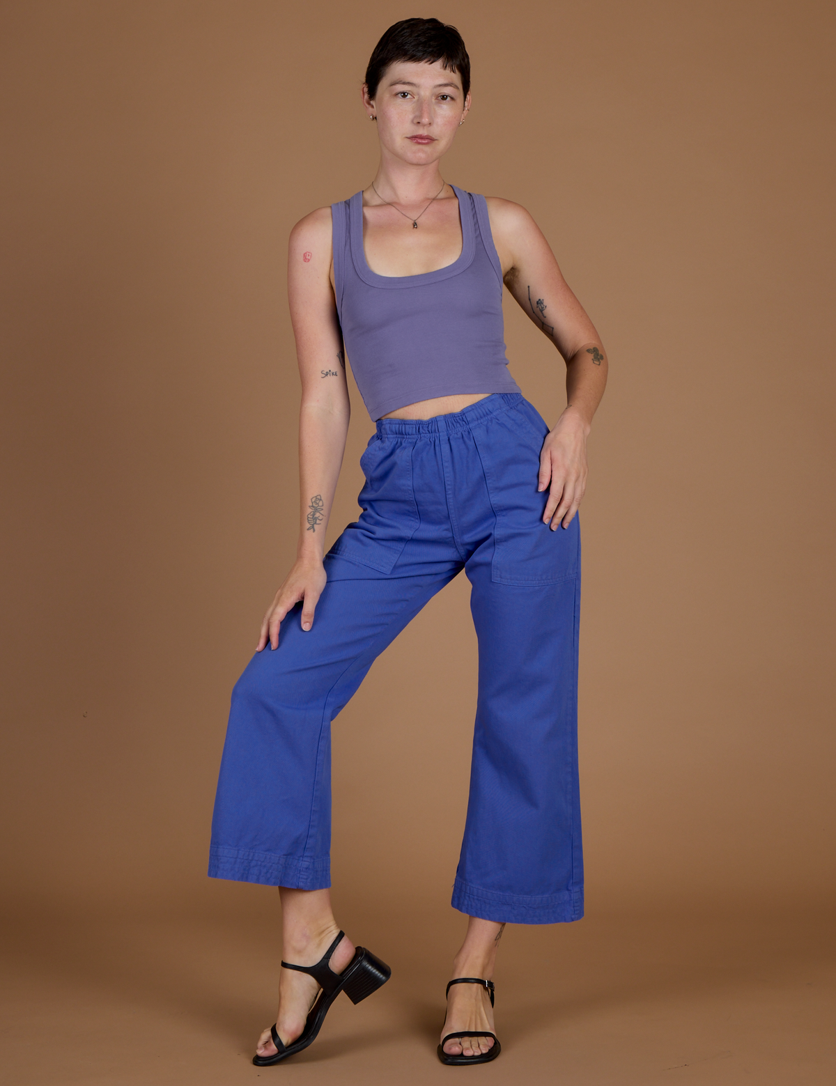 Alex is wearing the Cornflower Blue Action Pant with the Faded Grape Cropped Tank