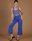 Alex is wearing the Cornflower Blue Action Pant with the Faded Grape Cropped Tank