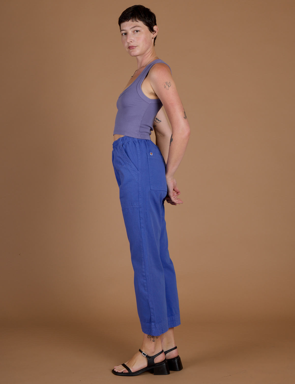Side view of Alex wearing the Cornflower Blue Action Pant and the Faded Grape Cropped Tank