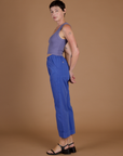 Side view of Alex wearing the Cornflower Blue Action Pant and the Faded Grape Cropped Tank