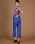 Angled back view of Alex in the Cornflower Blue Action Pant
