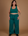 Kristen is 5'9" and wearing 2XL Hunter Green Action Pant with the Hunter Green Mini Tank