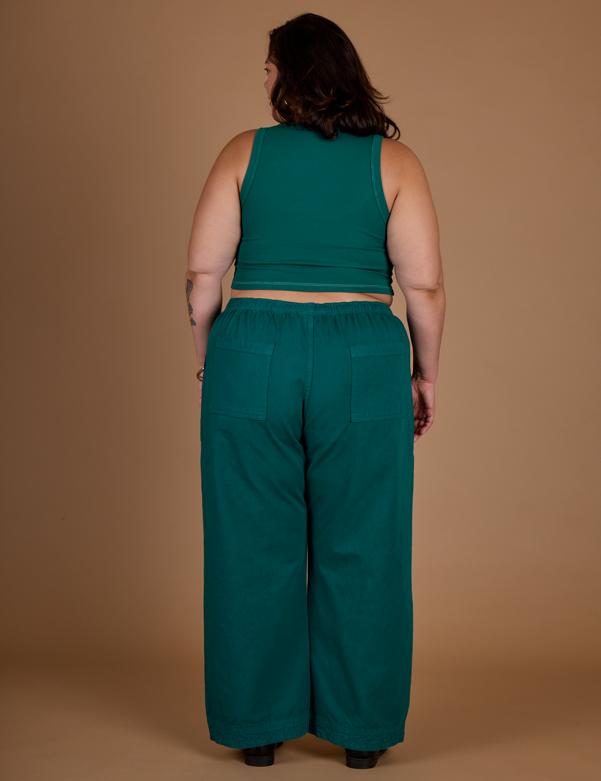 Back view of the Hunter Green Action Pant on Kristen
