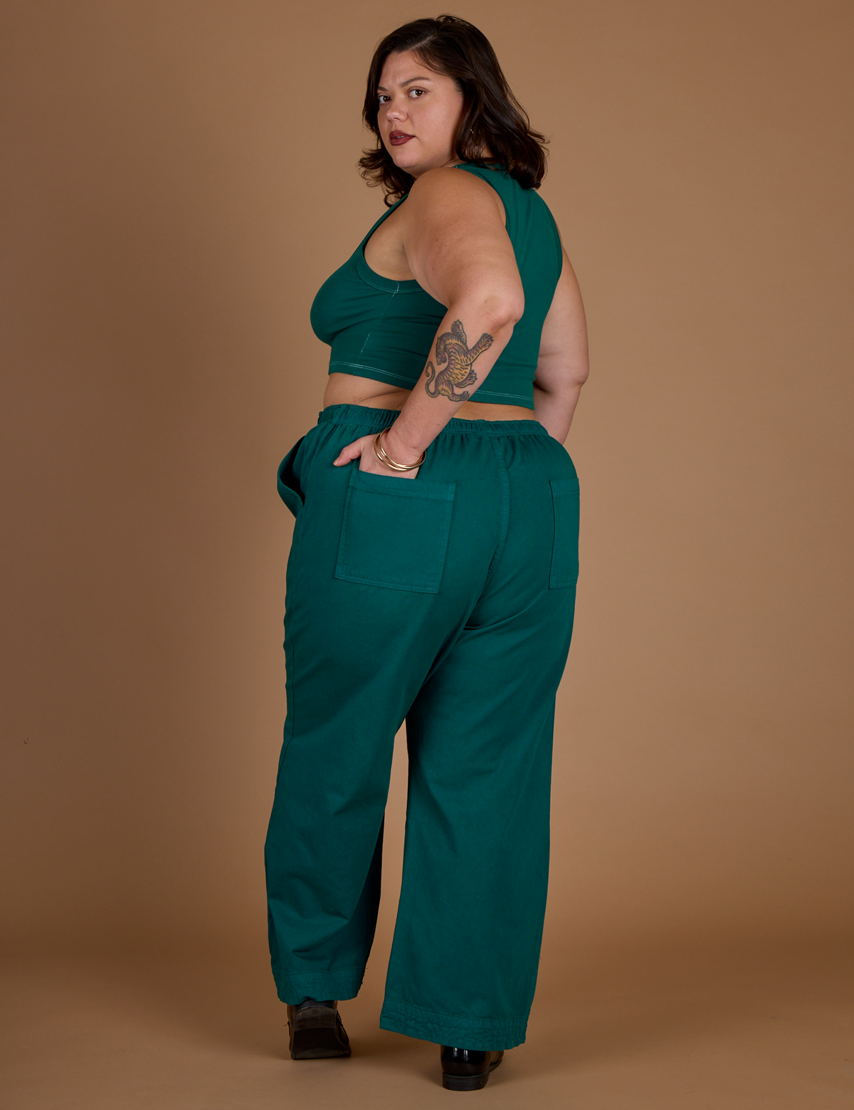 Angled back view of the Hunter Green Action Pant