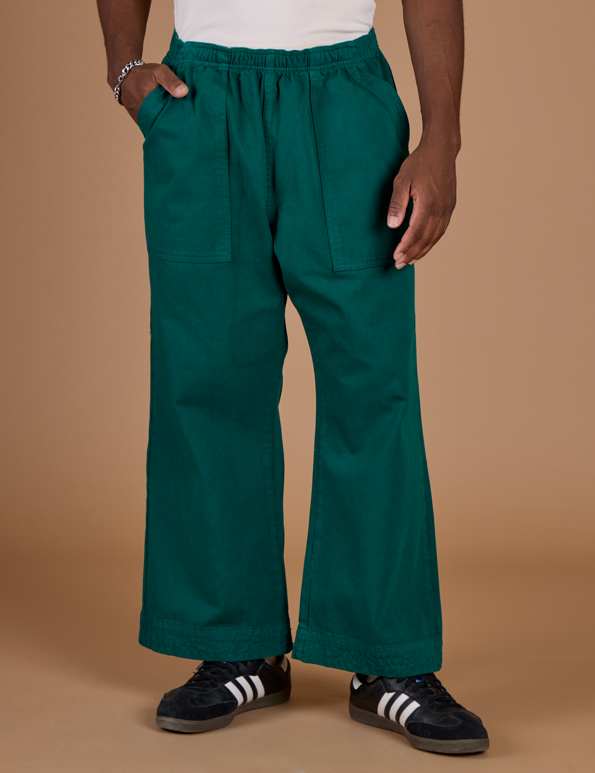 Hunter Green Action Pant with Isaac's hand in the front pocket