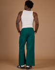 Back view of Isaac in the Hunter Green Action Pant