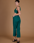 Angled back view of the Hunter Green Action Pant