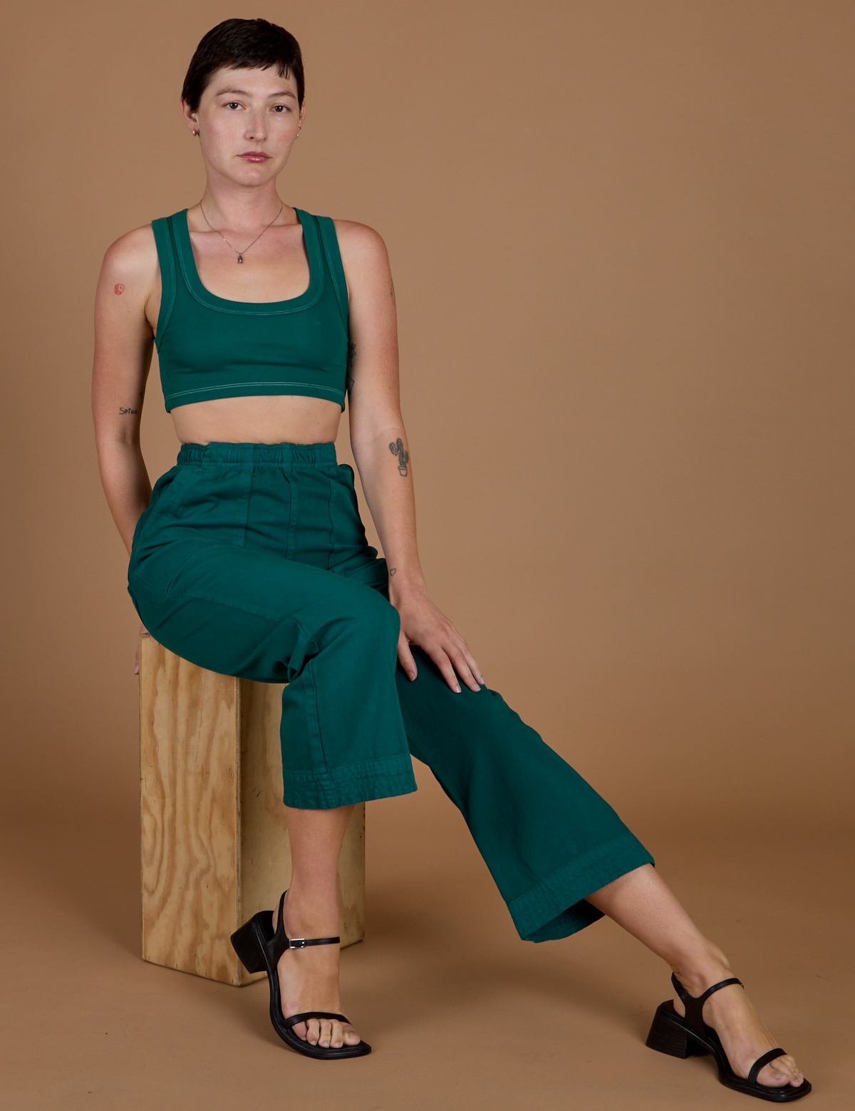 Alex wearing the Hunter Green Action Pant with the Hunter Green Mini Tank