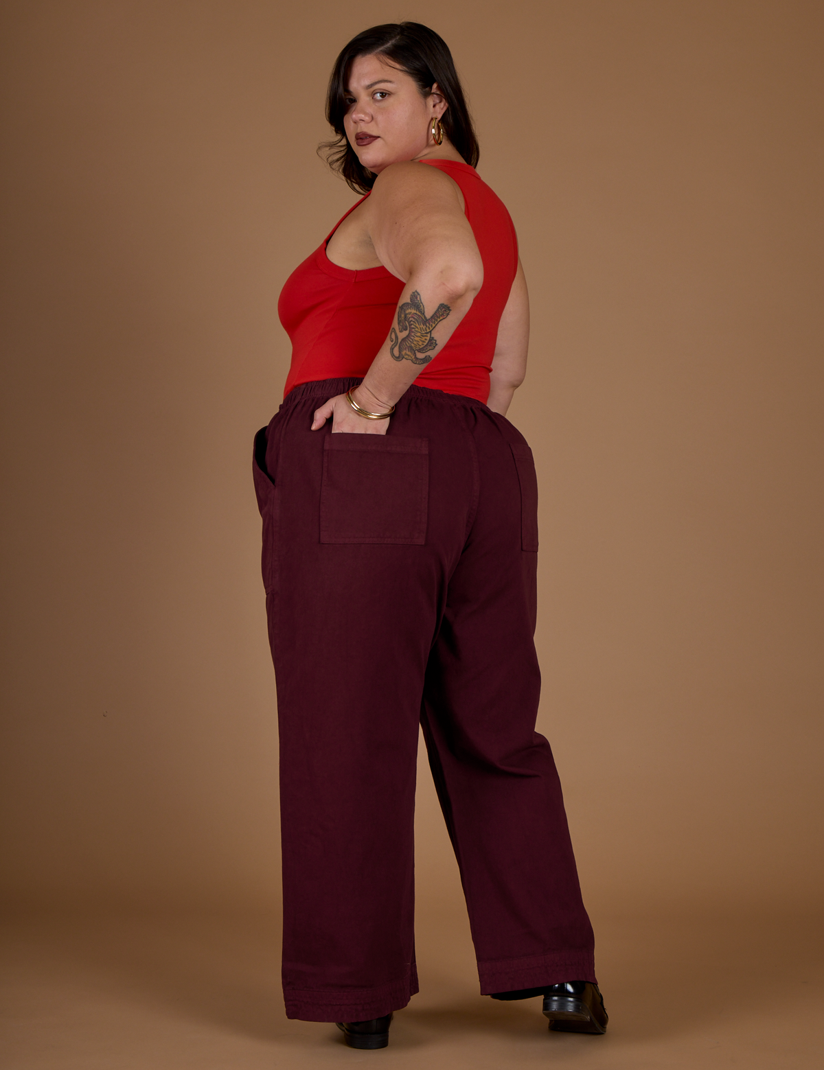 Angled back view of the Red Wine Action Pant on Kristen