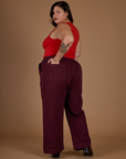 Angled back view of the Red Wine Action Pant on Kristen