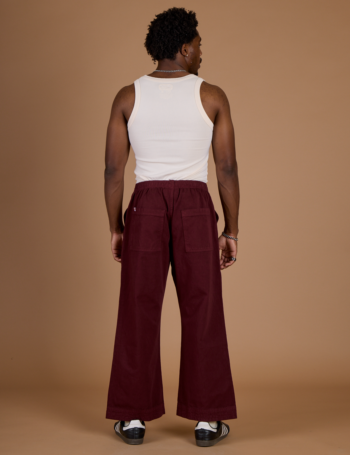 Back view of Isaac in the Red Wine Action Pant