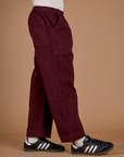 Side view of the Red Wine Action Pant on Isaac