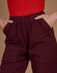 Close up of Alex's hands in the front pockets of the Red Wine Action Pant