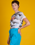 Side view of Alex in the Dark Cloud & Sky Airbrush Vintage Tee