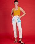 Alex is wearing the Pockets of Sky Airbrush Work Pants with the Mustard Yellow Cropped Tank
