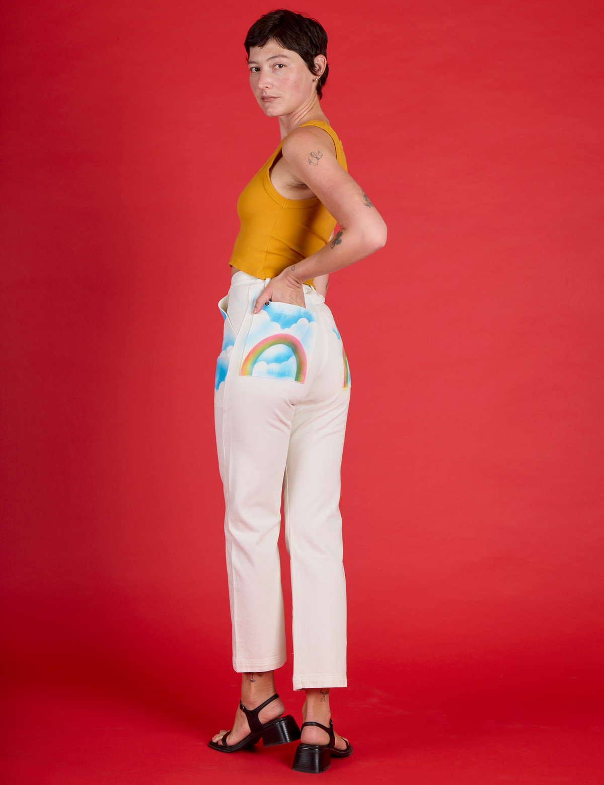 Angled back view of Alex wearing the Pockets of Sky Airbrush Work Pants