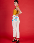 Angled back view of Alex wearing the Pockets of Sky Airbrush Work Pants