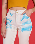 Alex's hand in the front pocket of the Pockets of Sky Airbrush Work Pants