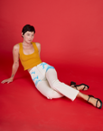 Alex in the Pockets of Sky Airbrush Work Pants with the Mustard Yellow Cropped tank