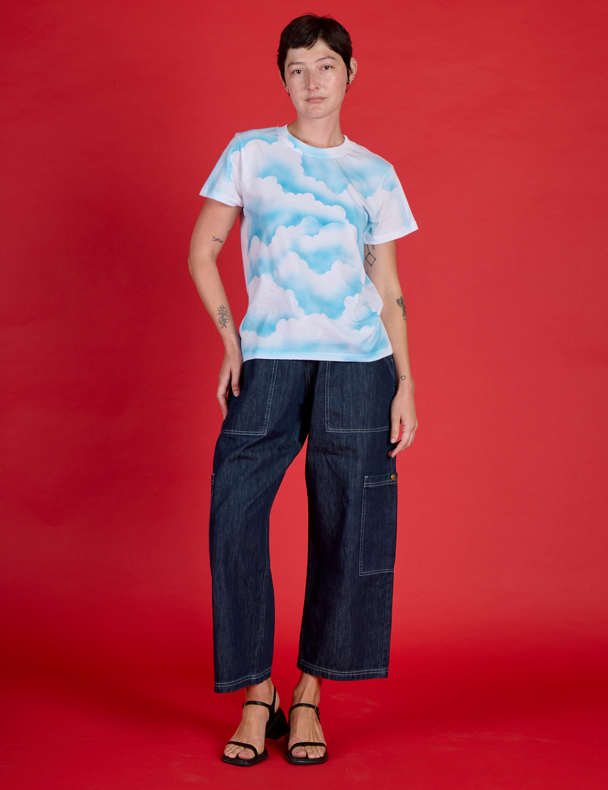 Alex is wearing the Cloud Coverage Airbrush Vintage Tee with Dark Wash Denim Drop Pocket Pants