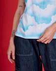 Close up of the Cloud Coverage Airbrush Vintage Tee's hemline on Alex