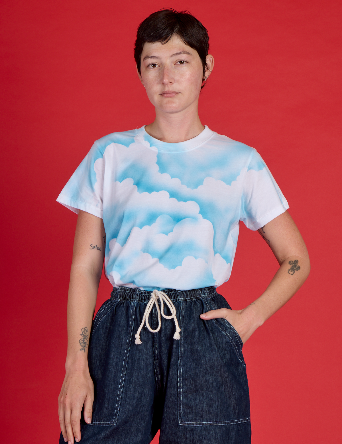 Alex is wearing the Cloud Coverage Airbrush Vintage Tee tucked in