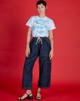 Alex wearing the Cloud Coverage Airbrush Vintage Tee tucked into the Dark Wash Denim Drop Pocket Pants