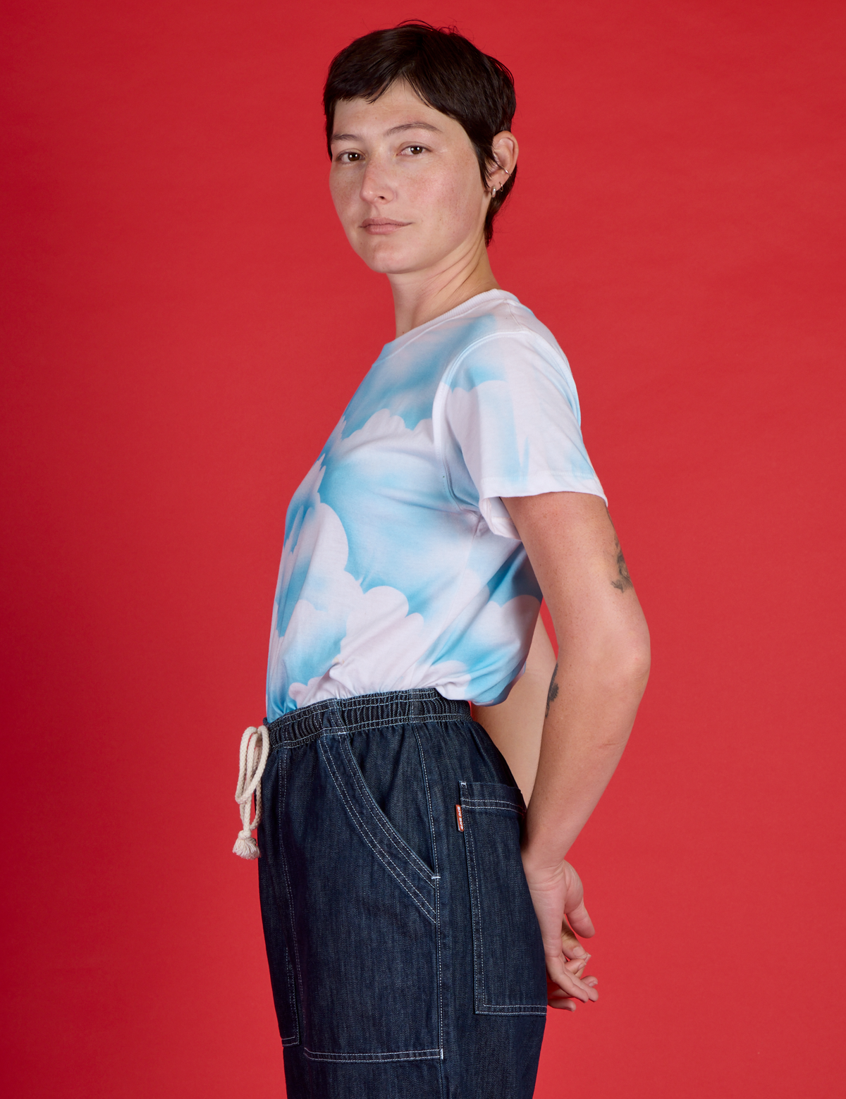 Side view of Alex wearing the Cloud Coverage Airbrush Vintage Tee
