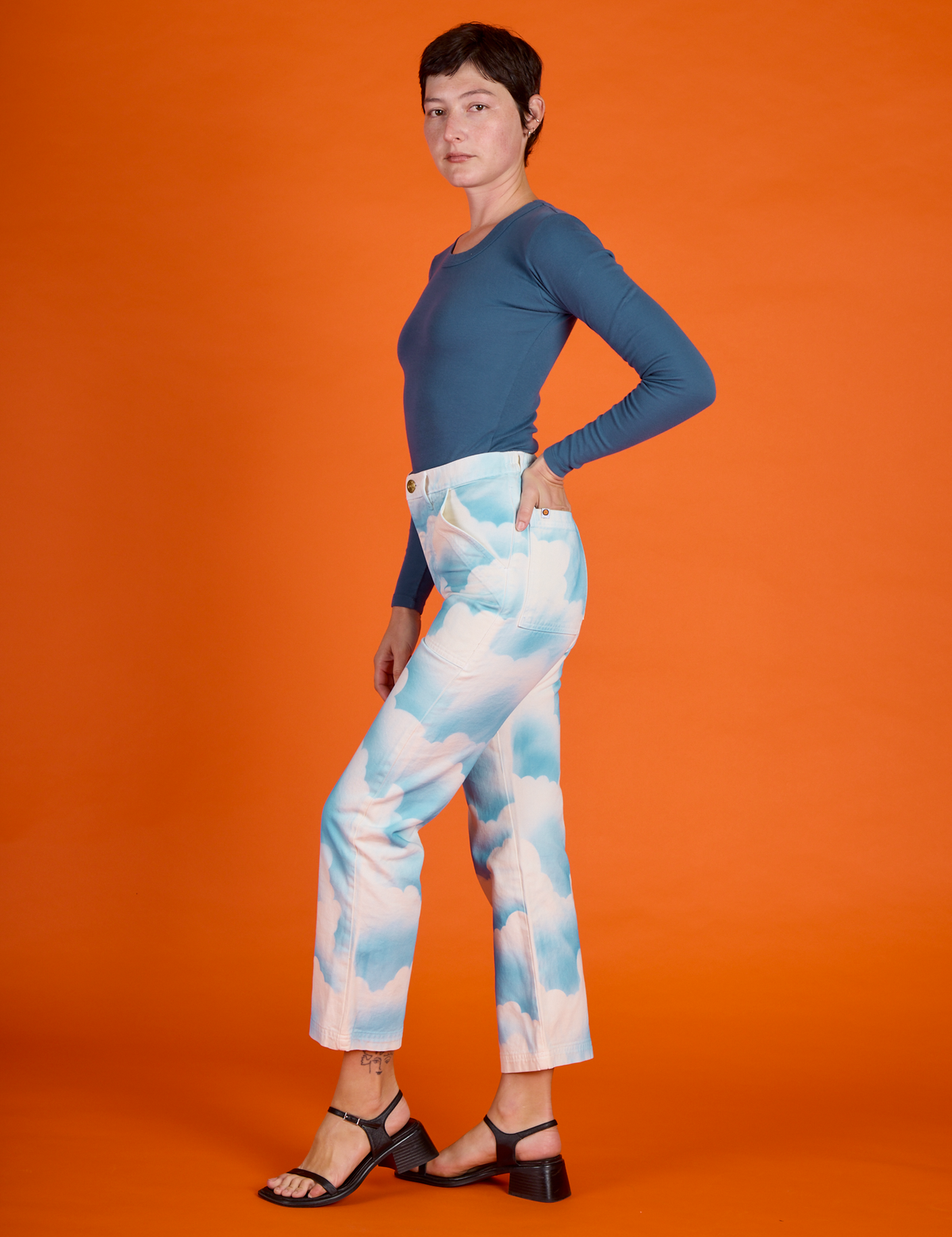 Side view of Alex in the Cloud Coverage Airbrush Work Pants