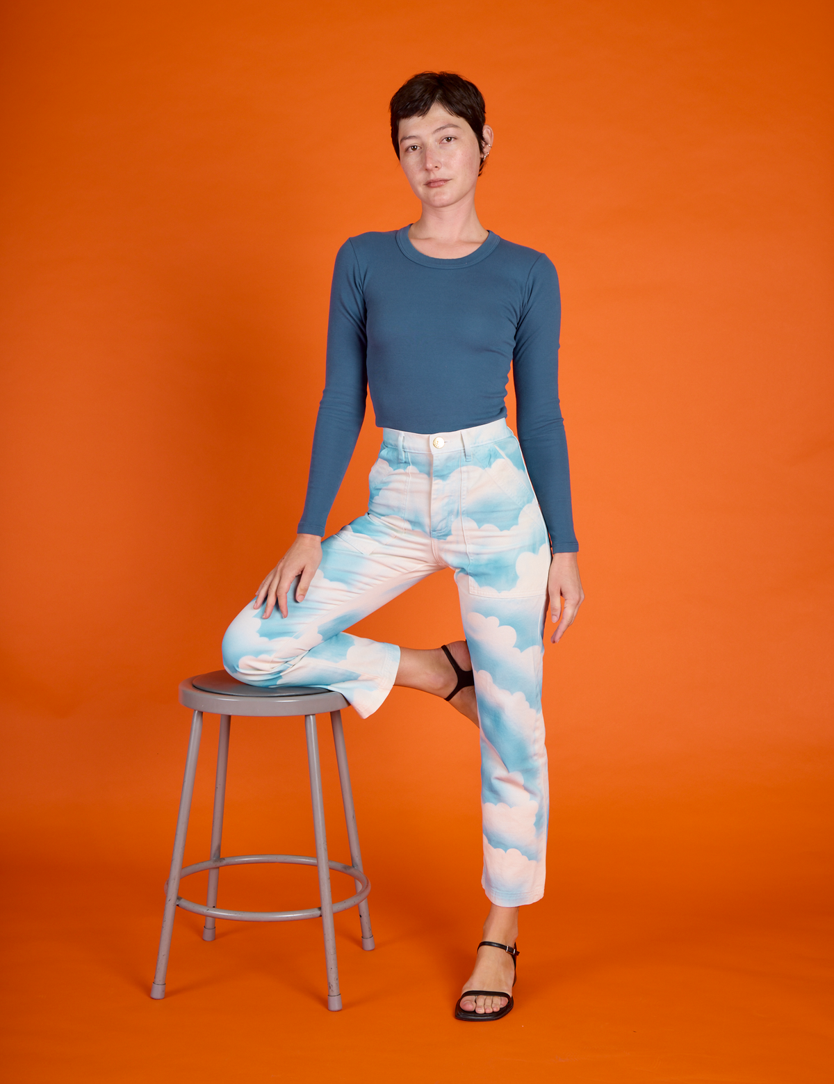 Alex wearing the Cloud Coverage Airbrush Work Pants with French Blue Long Sleeve Baby Tee