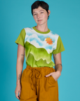 Alex is wearing the Green Hills Airbrush Vintage Tee tucked into the Spicy Mustard Drop Pocket Pants