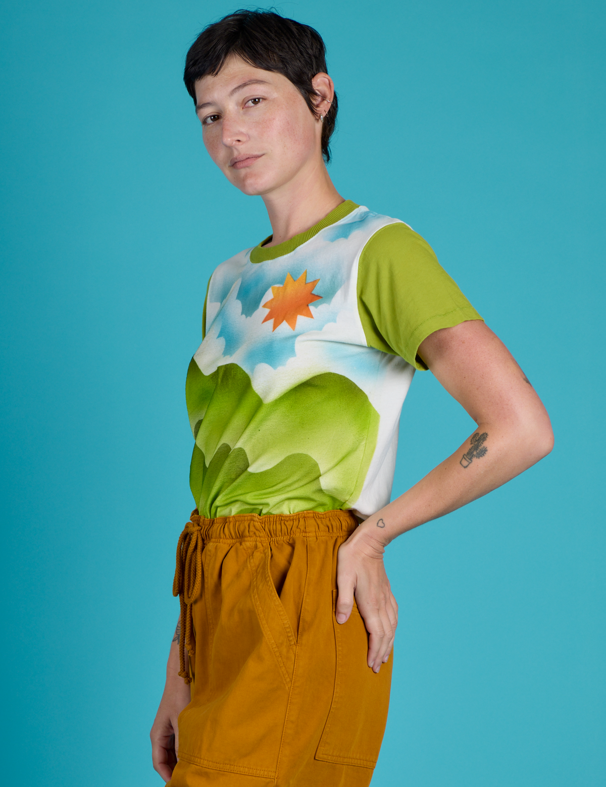 Side view of Alex wearing the Green Hills Airbrush Vintage Tee