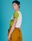 Angled back view of Alex in the Green Hills Airbrush Vintage Tee