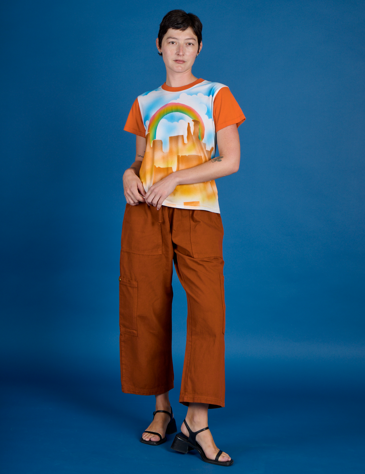 Alex is wearing the Orange Mesa Airbrush Vintage Tee with Burnt Terracaotta Drop Pocket Pants