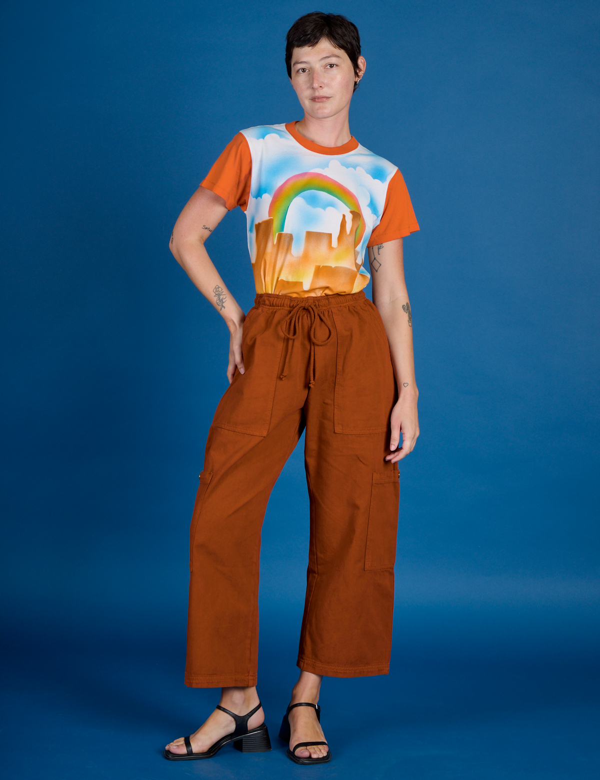 Alex wearing the Orange Mesa Airbrush Vintage Tee tucked into the Burnt Terracotta Drop Pocket Pants